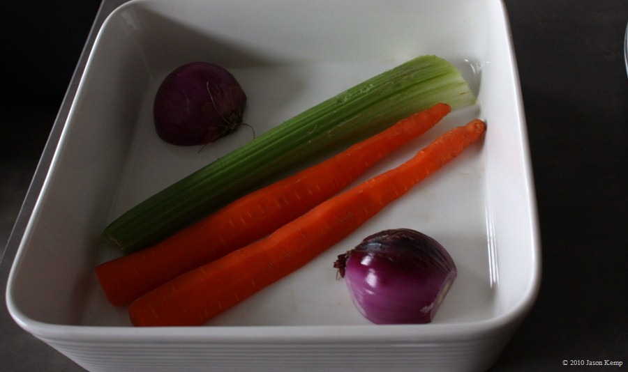 The veggies raise the chicken from the bottom of the pan, preventing sogginess and allowing air to circulate.